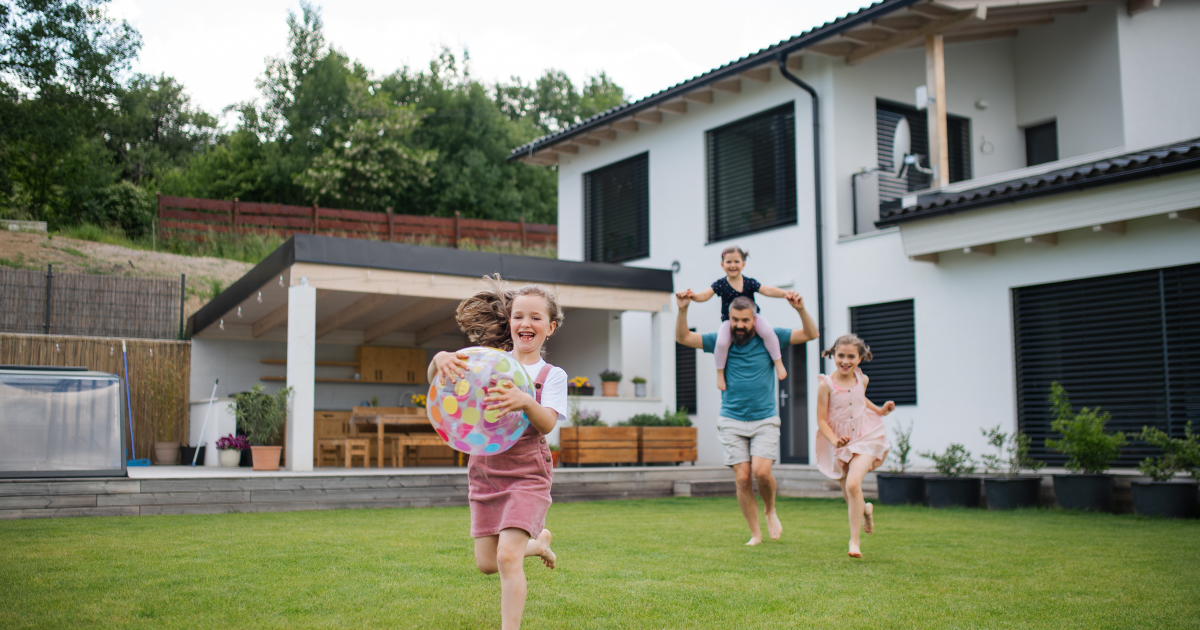 Father with three daughters playing outdoors. 