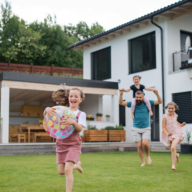 Father with three daughters playing outdoors. 