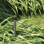Garden sprinkler system with water droplets on green grass
