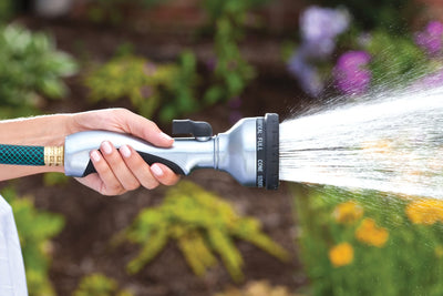 Metal ten pattern turret torch hose spray nozzle, emitting a full spray  of water. 