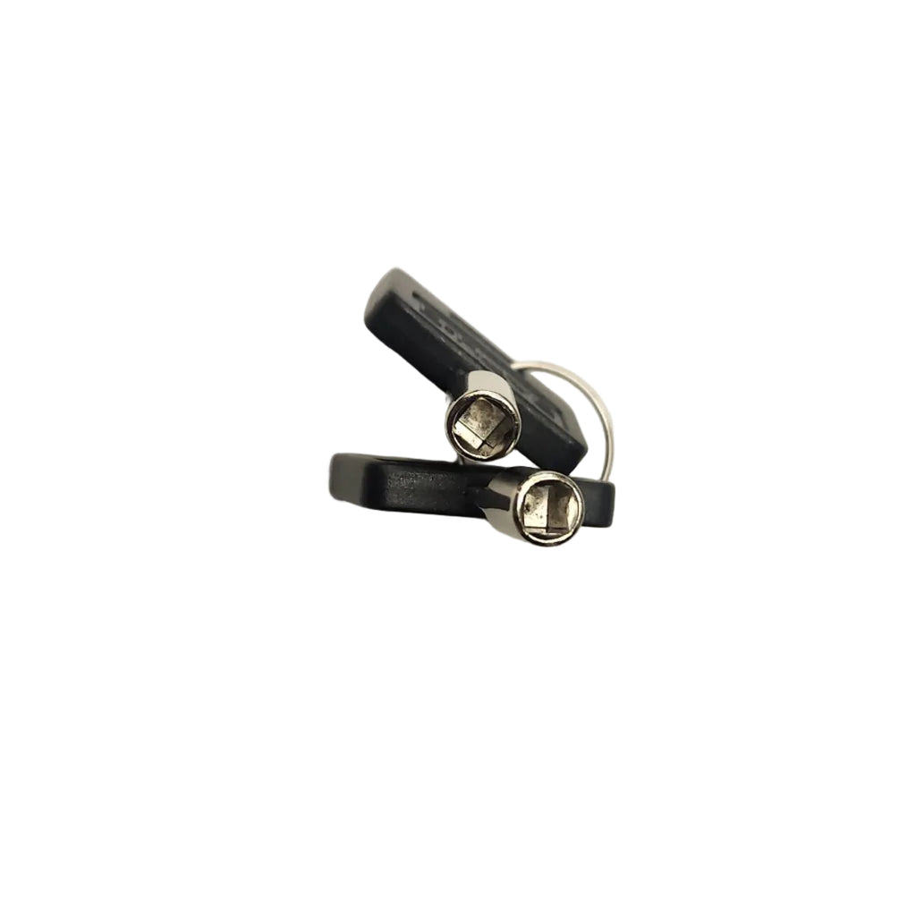 A pair of small black and silver metal earbud tips or ear hooks, shown on a plain off-white background.