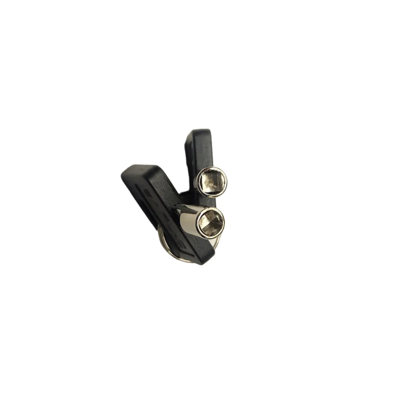 A pair of small black and silver metal hardware pieces, possibly bicycle headset components, placed on a plain white surface.