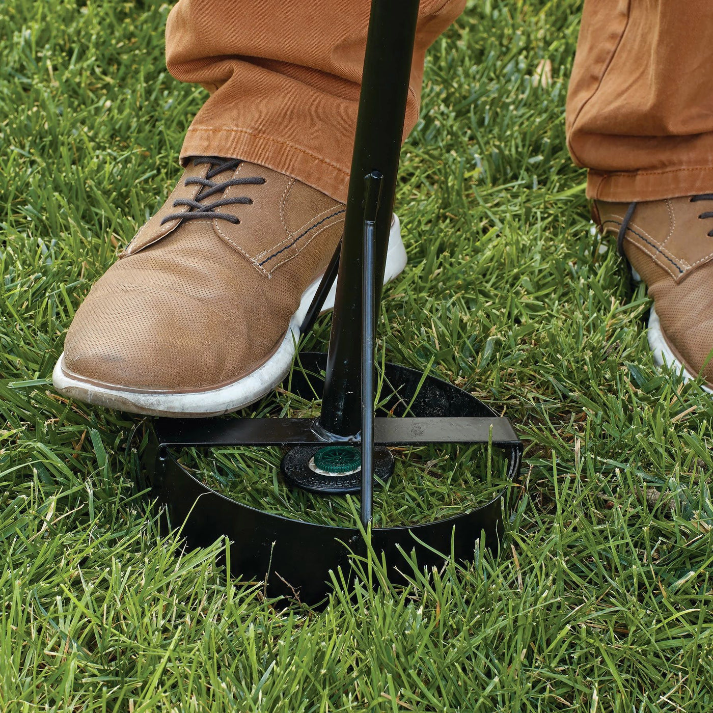 Seven inch sprinkler donut sod cutter. Being used to cut sod from the outer edges of a sprinkler head in the grass. 